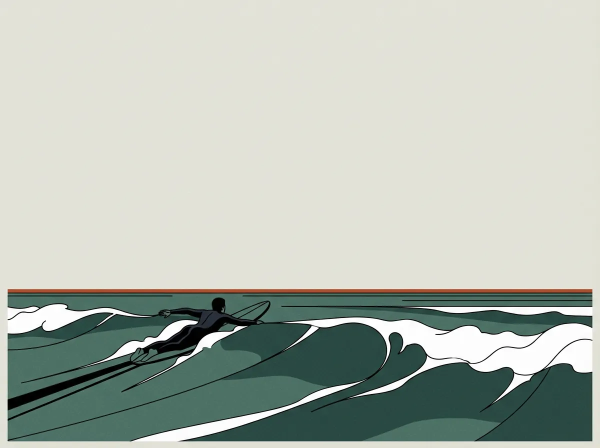 A lone surfer paddling out through the break at dawn